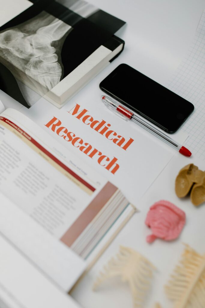 pexels-photo-7723397-7723397 Flat lay of medical research materials with books and anatomical models.